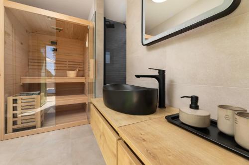 a bathroom with a black sink on a counter at Hidden House Porta in Krk