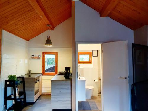 a kitchen with white walls and wooden ceilings at Zeit für uns in Cuxhaven
