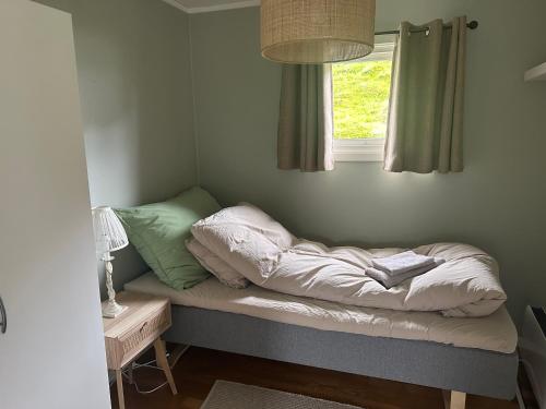 a bed sitting under a window in a room at Koselig hus i Beisfjord in Narvik