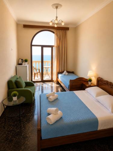 a hotel room with two beds and a balcony at Sunny Beach Hotel in Kobuleti