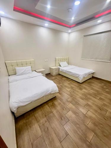 a room with two beds and a projection screen at شاليهات زارا 3 in Taif