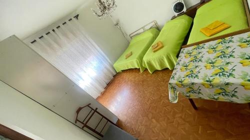 a small bedroom with a bed and green pillows at da Lilia in Salute&Bellezza Business Apartment in Monfalcone