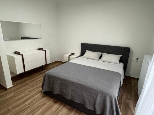 a bedroom with a large bed and a mirror at GreveLuxious in Grevena