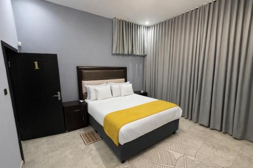 a bedroom with a large bed with a yellow blanket at Stylish Abode Guesthouse in Palatswe