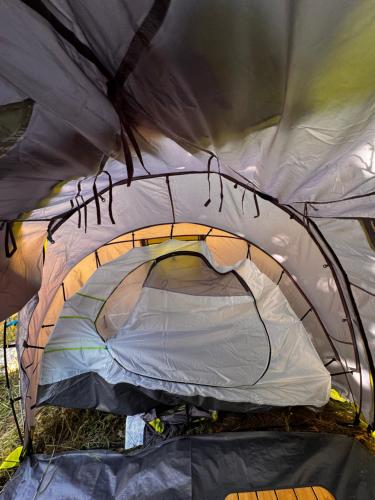 an inside of a tent with the door open at Pey camp in Saubion