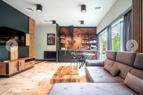 a living room with a couch and a table at Apartamenty Terminal Charzykowy in Charzykowy