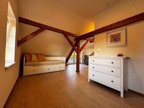 a bedroom with a bed and a dresser in a room at Apartmán U Medvěda in Vejprty