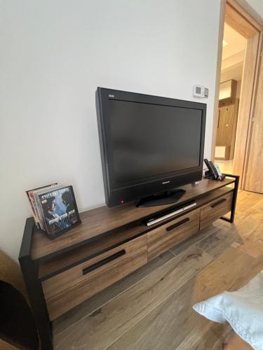 a flat screen tv sitting on top of a wooden entertainment center at Apartman Simikic in Lopare