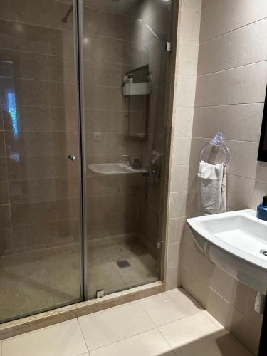 a bathroom with a glass shower and a sink at Alta-Home cabo in Cabo Negro