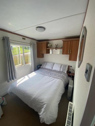 a bedroom with a large bed in a trailer at Angie Bs Beach Haven in Groomsport