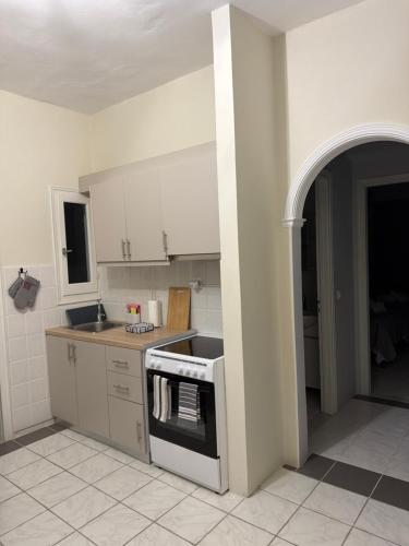 a kitchen with a sink and a stove top oven at Sidari Centre Apartments in Sidari