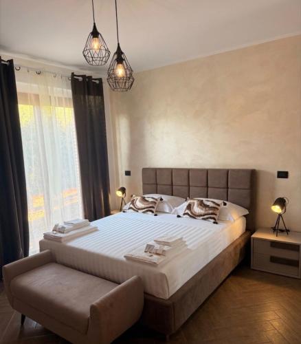 a bedroom with a large bed with a large window at Villa Sidoti in Calatabiano