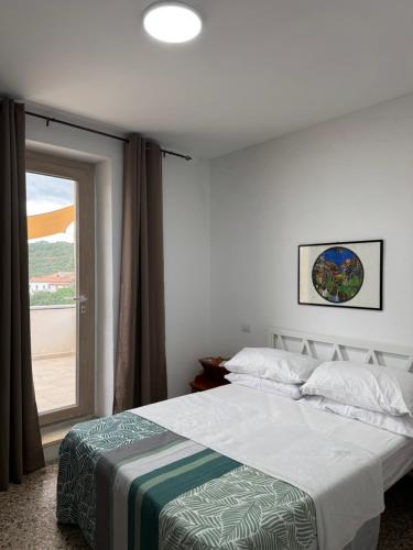 a bedroom with a bed and a sliding glass door at La Funtanella in Aggius
