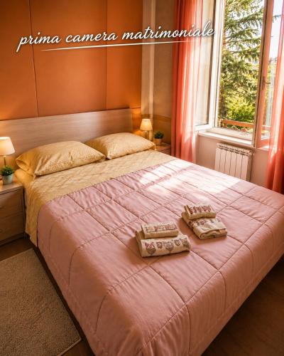 a bedroom with a bed with two towels on it at RESIDENCE ALTAIR Via Roma 13 in Ovindoli