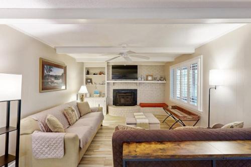 a living room with a couch and a fireplace at Meant To Beach in Edisto Beach