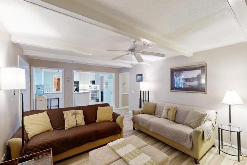 a living room with a couch and a ceiling fan at Meant To Beach in Edisto Beach