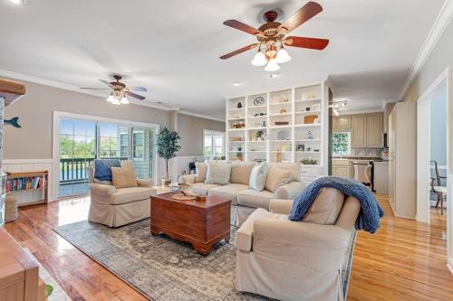 a living room with two couches and a ceiling fan at Sto-Away in Edisto Beach