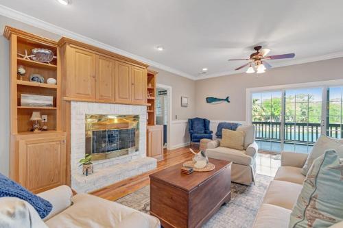 a living room with a fireplace and a couch at Sto-Away in Edisto Beach