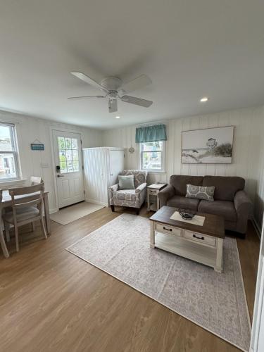 a living room with a couch and a table at 2 Minute Walk to Beach, Cape Cod Escape in Dennis Port