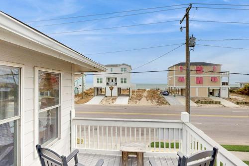 a porch of a house with a bench and a street at The Answer in Edisto Island