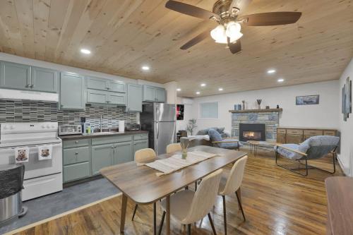 a kitchen and dining room with a table and a fireplace at Private Cozy Cabin with Fire Pit in Locust Lakes Village