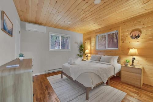 a bedroom with a bed with a wooden ceiling at Private Cozy Cabin with Fire Pit in Locust Lakes Village