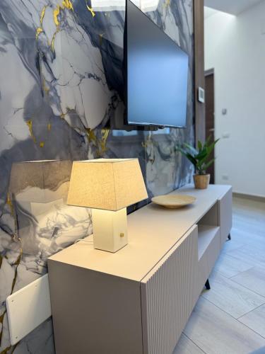 a desk with a television on top of it at Cagrovi Apartments in Casoria