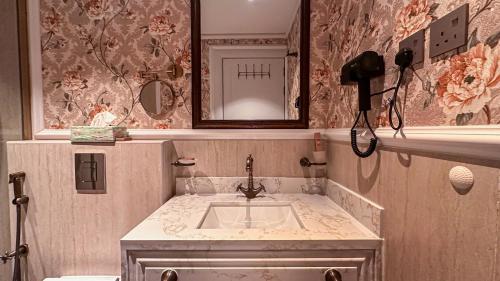 a bathroom with a sink and a mirror at The Classic Palace in Abha