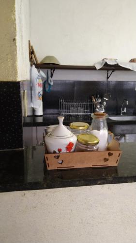 a tray with vases and bowls on a shelf at Sítio Topo do Vale in Sabará