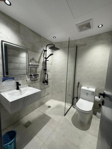 a bathroom with a toilet and a sink and a shower at Nuzul Nebras Al Madinah in Medina