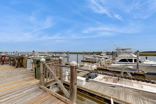 a bunch of boats docked at a dock at Bay Creek Villa - 202 in Edisto Beach