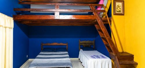 two bunk beds in a room with blue walls at Sítio Topo do Vale in Sabará