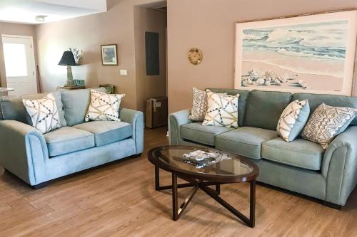 a living room with two couches and a coffee table at Morillo's Miracle in Edisto Beach