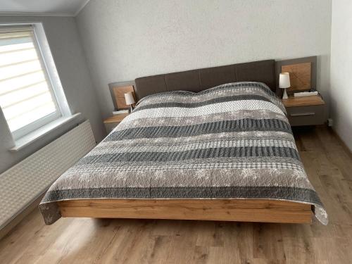 a bedroom with a bed with a blanket on it at Nina in Bad Wildungen