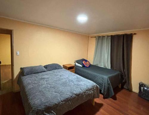 a bedroom with a bed and a chair in it at Hospedaje marylin in La Serena