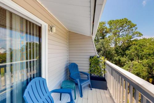 two blue chairs sitting on a porch at Driftwood Villa - 259 in Edisto Beach