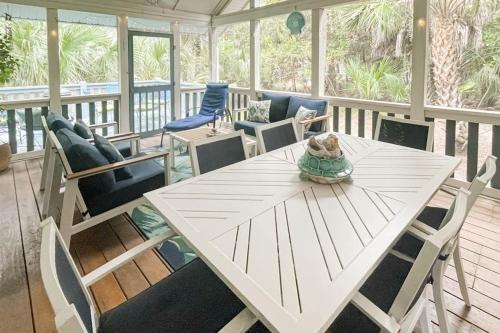 a teddy bear sitting on a table on a porch at Artsea Phartsea in Edisto Beach