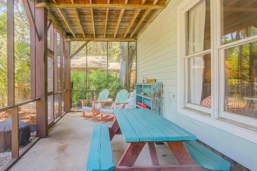 a porch with a blue picnic table and chairs at Goldie's Retreat in Edisto Beach