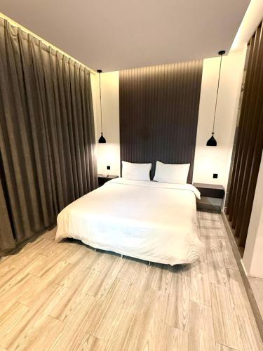 a bedroom with a white bed with two pillows at شاليهات سمو بارك in Taif