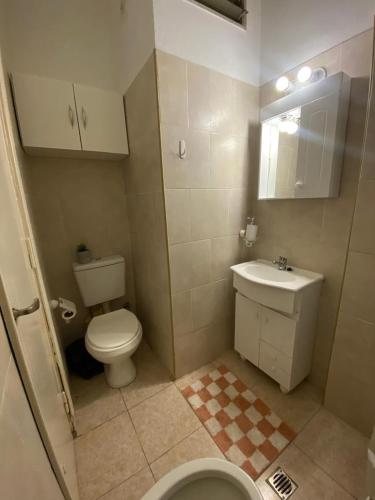 a small bathroom with a toilet and a sink at Departamento Adrián in Mar del Plata