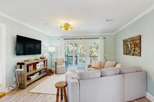 a living room with a couch and a tv at Heaven on Harrelson in Edisto Beach