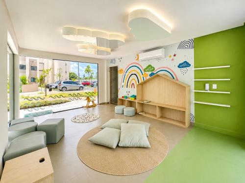 a living room with a rainbow mural on the wall at FLAT RESORT LUXO MALIA 215E- Porto de Galinhas - Muro Alto in Porto De Galinhas