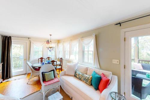 a living room with a couch and a table at Pink Bird Cottage in Edisto Beach