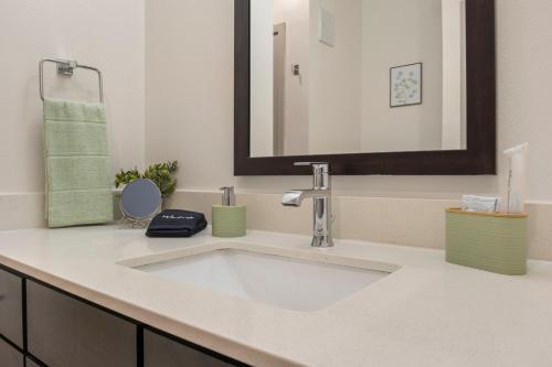 a bathroom with a white sink and a mirror at Walk to Toyota Stadium in Frisco