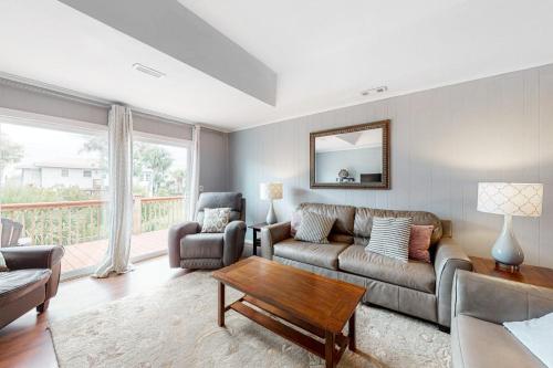 a living room with a couch and a table at Hamptons South in Edisto Beach