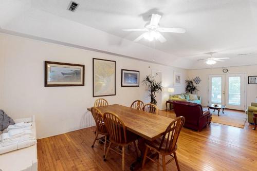 a dining room and living room with a table and chairs at Sand Quarters in Edisto Beach