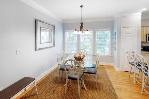 a dining room with a glass table and chairs at Chateau Relaxo in Edisto Beach