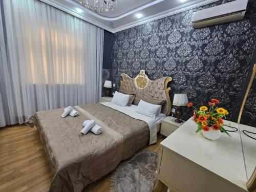 a bedroom with a bed with two towels on it at Riverside Villa GDR in Gabala