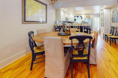 a dining room with a wooden table and chairs at Stare-Gazing in Edisto Beach