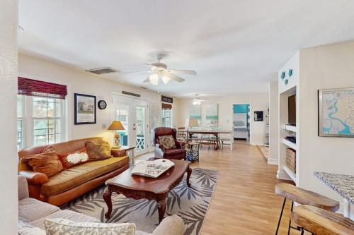 a living room with a couch and a table at Summer House in Edisto Beach